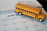 toy school bus sitting on a calendar 